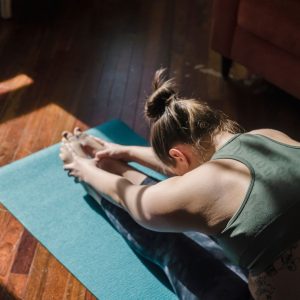 stretching on a floor mat for reconnective yoga